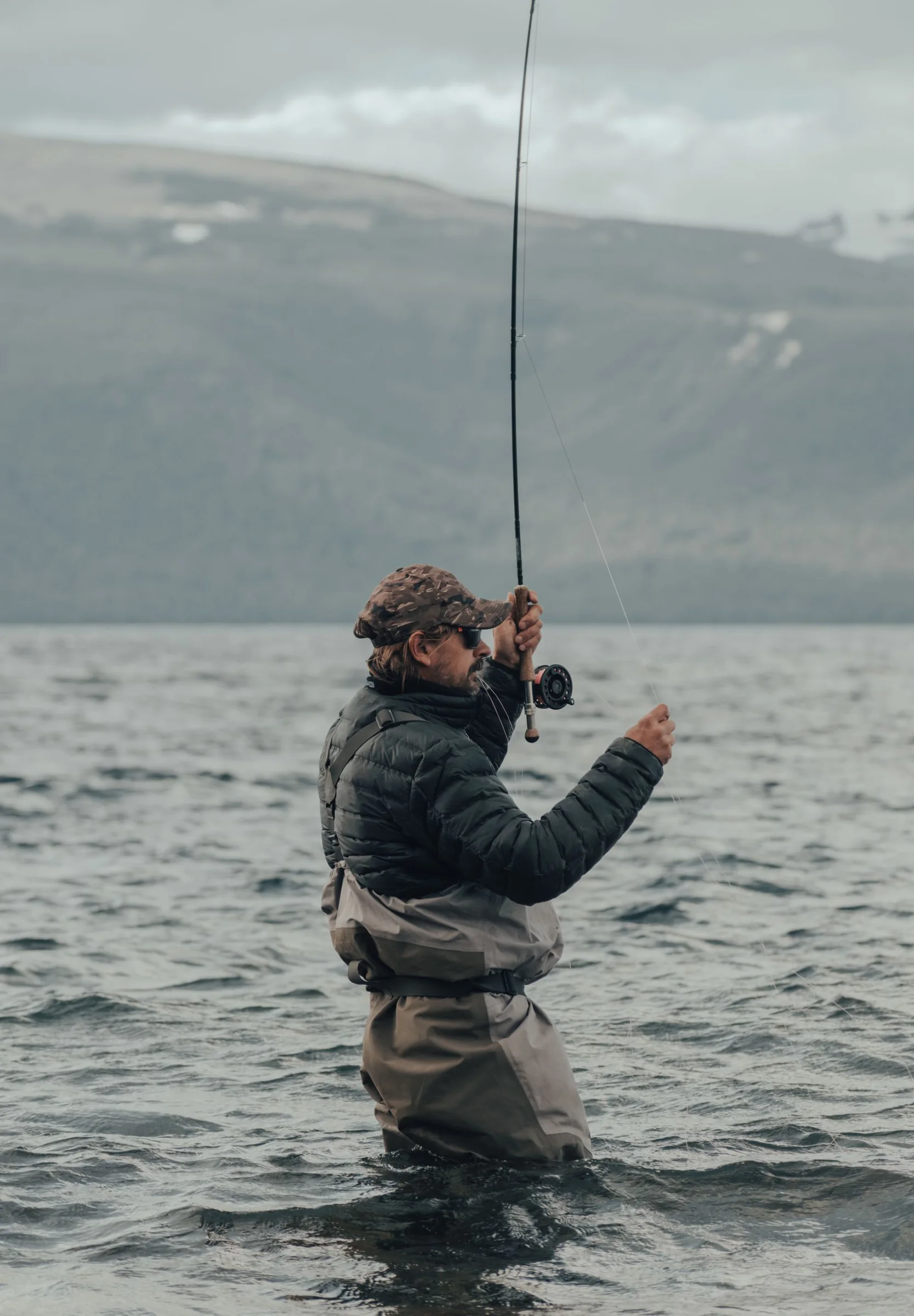 Angler standing in a mountain lake