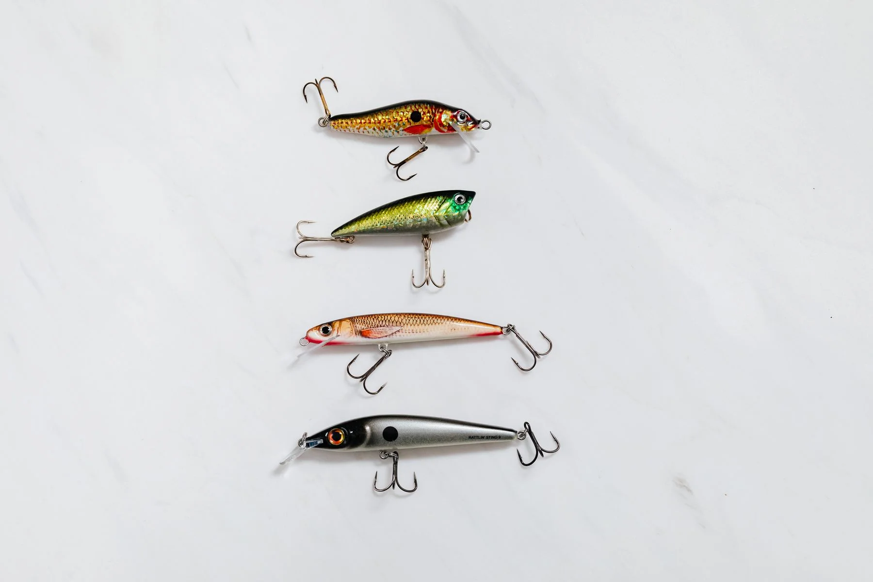 Assorted lures arranged on a white surface